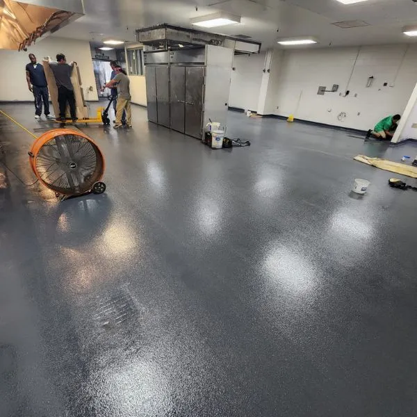 Dark gray gloss coating across a commercial floor