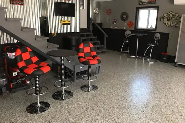 Flake epoxy floor in a garage lounge with bar stools, Taylorsville, Utah