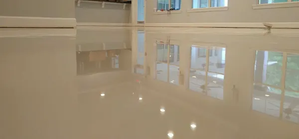 Cream high-gloss epoxy floor reflecting the windows, South Salt Lake, Utah