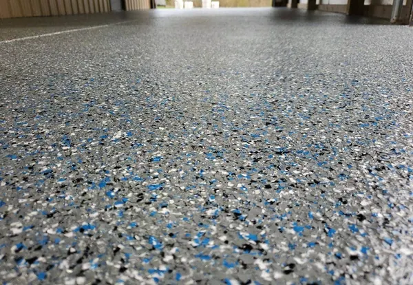 Blue, gray and black flake epoxy garage floor up close