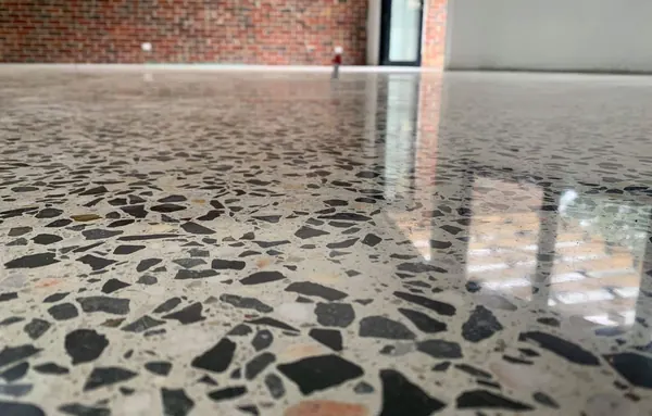 Terrazzo-look polished concrete floor beside a brick wall, South Salt Lake, Utah